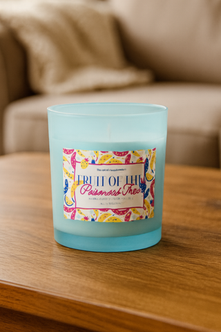 Blue candle with a colorful label on a wooden surface