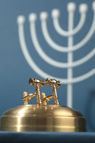 Scales of justice with menorah in the background with a blue background