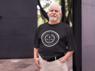 Man wearing a black t-shirt with a white logo outdoors